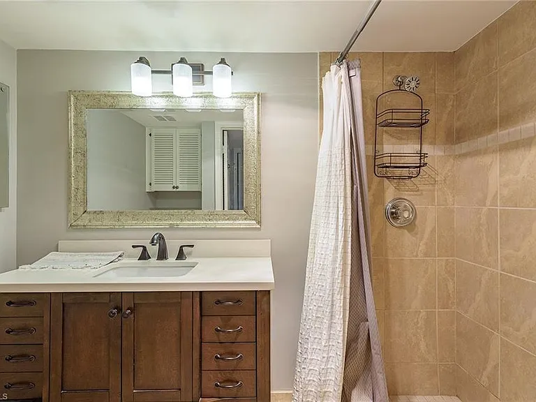 Bathroom vanity beside a tiled shower