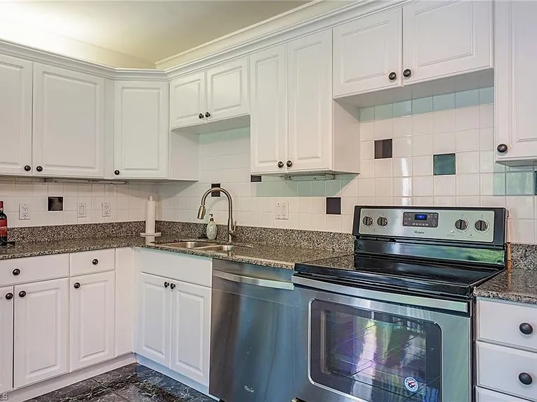 Kitchen with white cabinetry and stainless-steel appliances